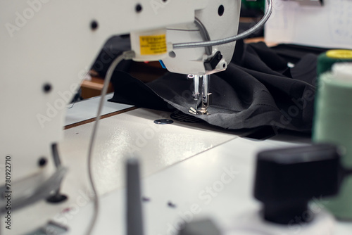 Close-up stitching process on a sewing machine. photo