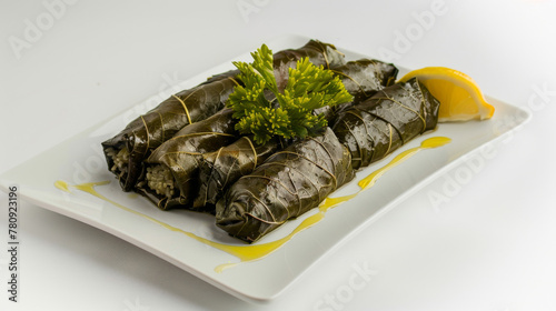 Delicious iraqi dolma with grape leaves, rice, and lemon on a modern plate