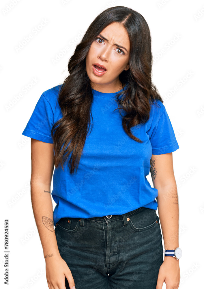 Beautiful brunette young woman wearing casual clothes in shock face, looking skeptical and sarcastic, surprised with open mouth Beautiful brunette young woman wearing casual clothes in shock face, looking skeptical and sarcastic, surprised with open mouth