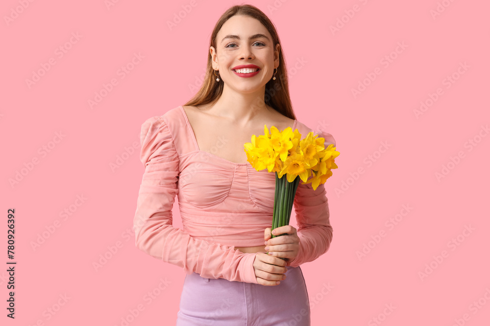 Happy young woman with bouquet of daffodil flowers on pink background Happy young woman with bouquet of daffodil flowers on pink background