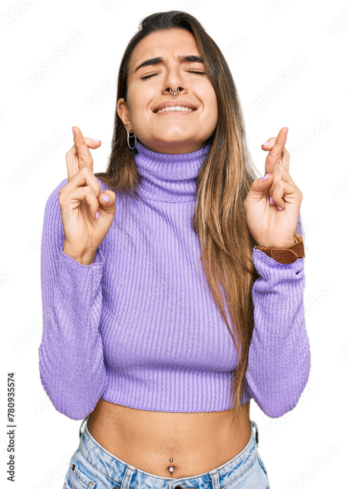Young hispanic woman wearing casual clothes gesturing finger crossed smiling with hope and eyes closed. luck and superstitious concept. Young hispanic woman wearing casual clothes gesturing finger crossed smiling with hope and eyes closed. luck and superstitious concept.