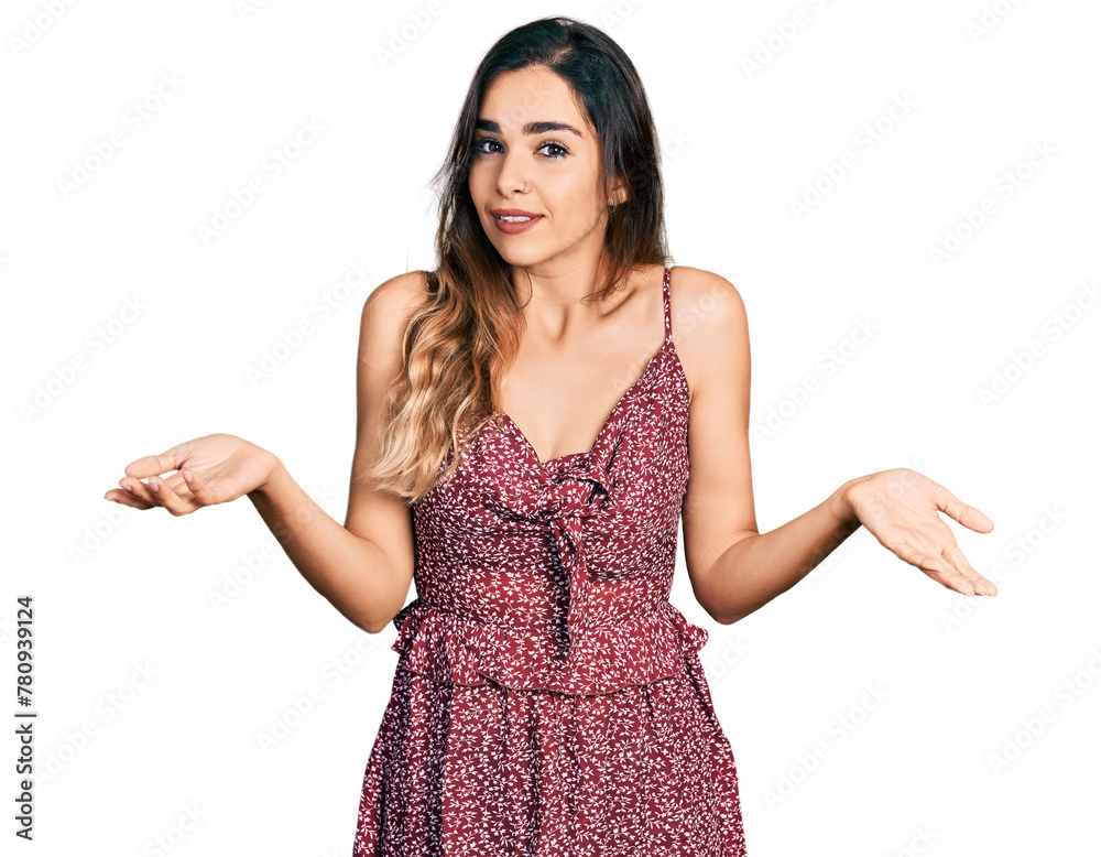Beautiful hispanic woman wearing summer dress clueless and confused expression with arms and hands raised. doubt concept. Beautiful hispanic woman wearing summer dress clueless and confused expression with arms and hands raised. doubt concept.
