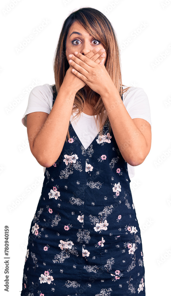 Young beautiful woman wearing casual floral dress shocked covering mouth with hands for mistake. secret concept. Young beautiful woman wearing casual floral dress shocked covering mouth with hands for mistake. secret concept.