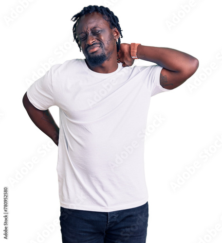 Young african american man with braids wearing casual white tshirt suffering of neck ache injury, touching neck with hand, muscular pain