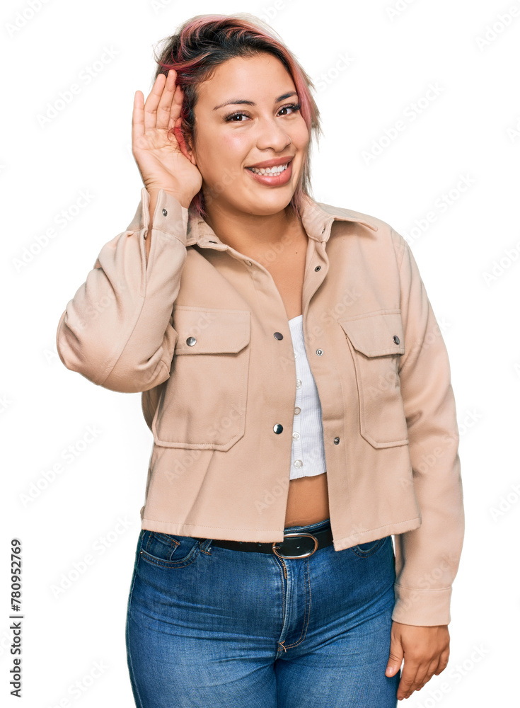 Hispanic woman with pink hair wearing casual clothes smiling with hand over ear listening an hearing to rumor or gossip. deafness concept. Hispanic woman with pink hair wearing casual clothes smiling with hand over ear listening an hearing to rumor or gossip. deafness concept.