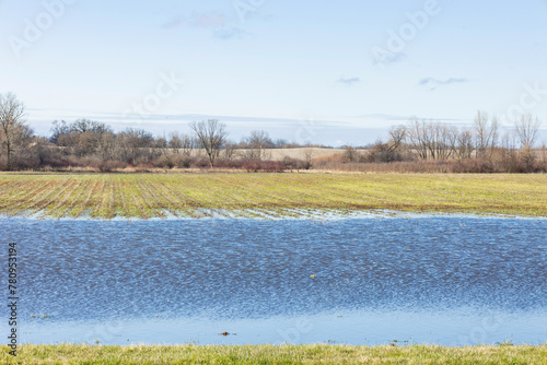 Flooded fields in the early spring with a blue sky. 