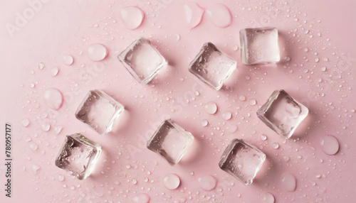Top view photo of scattered ice cubes and water drops on isolated pastel pink background photo