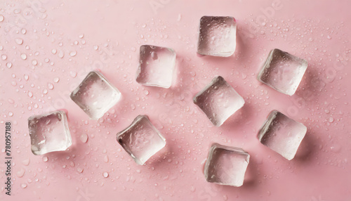 Top view photo of scattered ice cubes and water drops on isolated pastel pink background photo