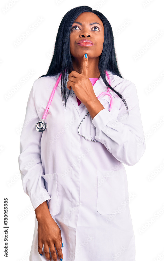 Young african american woman wearing doctor stethoscope thinking concentrated about doubt with finger on chin and looking up wondering Young african american woman wearing doctor stethoscope thinking concentrated about doubt with finger on chin and looking up wondering