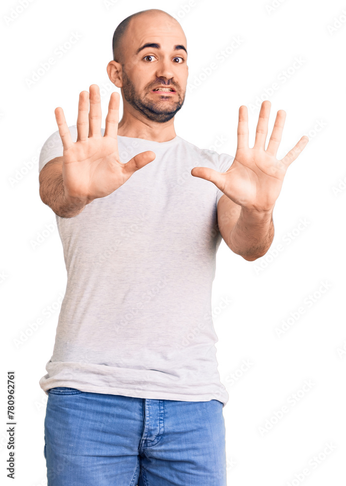 Young handsome man wearing casual t shirt afraid and terrified with fear expression stop gesture with hands, shouting in shock. panic concept. Young handsome man wearing casual t shirt afraid and terrified with fear expression stop gesture with hands, shouting in shock. panic concept.