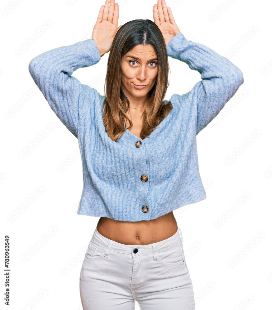 Young woman wearing casual clothes doing bunny ears gesture with hands palms looking cynical and skeptical. easter rabbit concept. - obrazy, fototapety, plakaty 