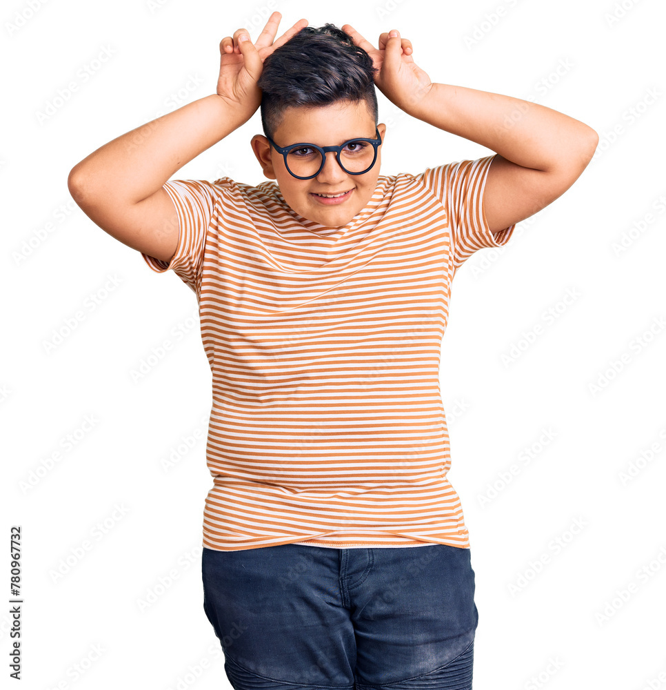 Little boy kid wearing casual clothes and glasses posing funny and crazy with fingers on head as bunny ears, smiling cheerful Little boy kid wearing casual clothes and glasses posing funny and crazy with fingers on head as bunny ears, smiling cheerful