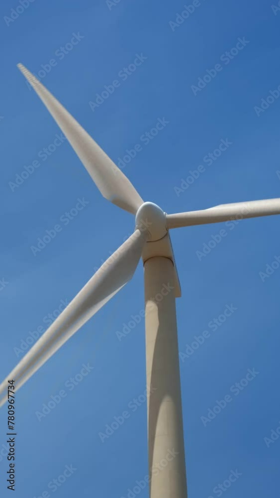 Green renewable alternative energy concept - wind generator turbine generating electricity in sky Green renewable alternative energy concept - wind generator turbine generating electricity in sky