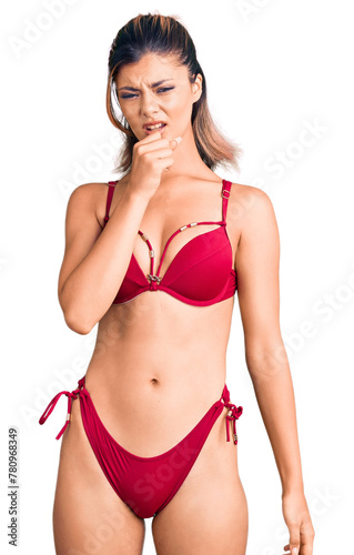Young beautiful woman wearing bikini feeling unwell and coughing as symptom for cold or bronchitis. health care concept. © Krakenimages.com