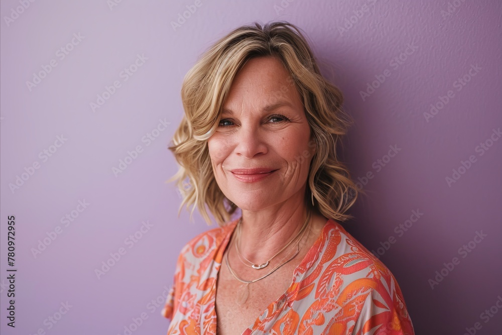 Portrait of mature woman with short hair standing against purple background. Portrait of mature woman with short hair standing against purple background.
