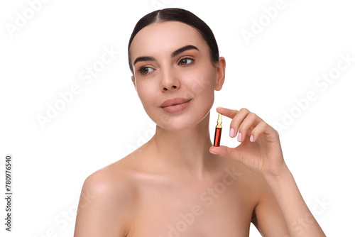 Beautiful young woman holding skincare ampoule on white background