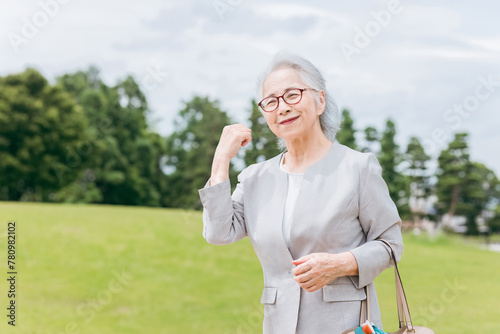 公園でガッツポーズするスーツ姿のシニア女性（経営者・政治家・アクティブシニア・生き生き）
 photo