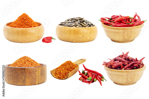 Cayenne pepper and fresh red chili with sunflower seeds in a wooden bowl chili spicy seasoning Isolated on a white background - clipping path.