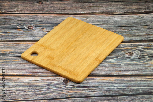 Wood cutting board for homemade bread cooking isolated on rusty background. Empty wooden tray at rusty