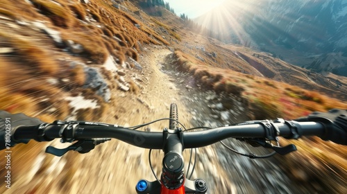 A close up of a mountain bike rider on a dirt road. photo