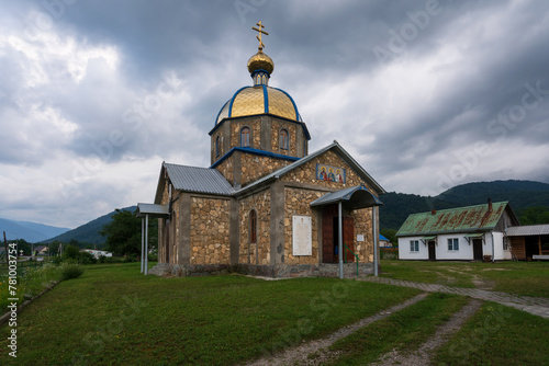 View of the Church of the Holy Martyrs Guria Samon and Aviva in the village of Khamyshki on a cloudy summer day, Republic of Adygea, Russia