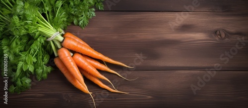 Fresh orange carrots arranged neatly on a weathered wooden table, creating a simple and natural composition photo