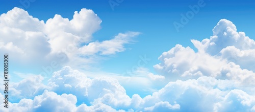 A commercial airplane in flight under a partly cloudy sky with fluffy white clouds