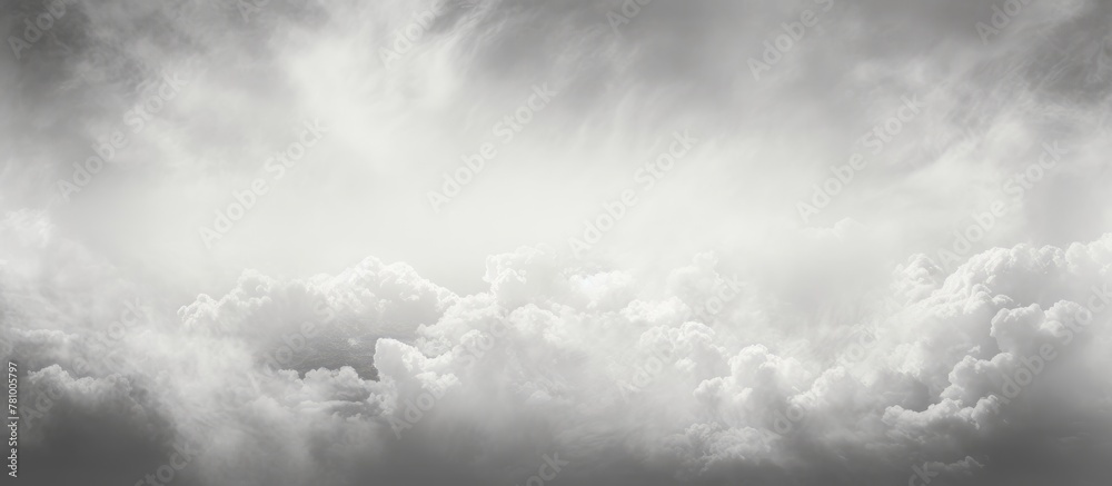 Obraz premium Flying high amidst billowing clouds, a plane traverses the black and white sky with elegance and power