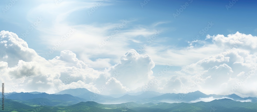 Landscape of mountains against cloudy sky with sun in background Landscape of mountains against cloudy sky with sun in background