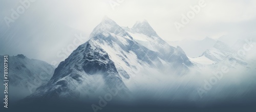 Snow-capped peak of a majestic mountain in the distant background under a clear sky