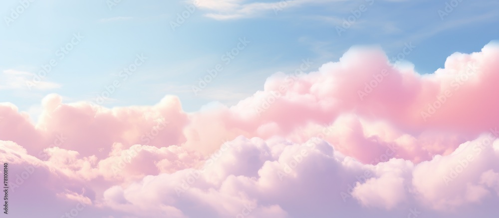 Pink fluffy cloud contrasting against clear blue sky in the background