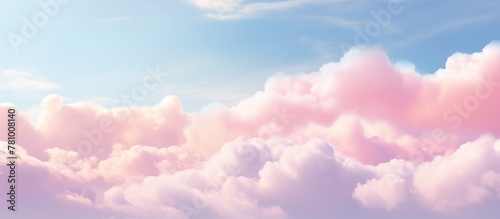 Pink fluffy cloud contrasting against clear blue sky in the background photo