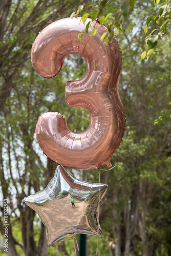 Helium inflated balloon of the number three photo