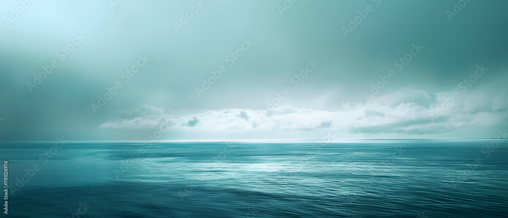 A calm ocean with a cloudy sky in the background. The sky is a mix of blue and gray, giving the scene a serene and peaceful atmosphere