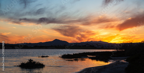 Vibrant sunset over salt lake in Cyprus Larnaca in spring with orange sky and clouds