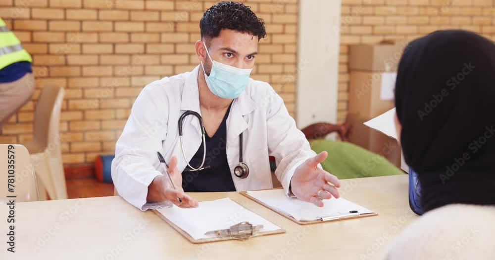 Doctor, man and health outreach for community service with consultation, clipboard checklist or helping. NGO, charity or volunteer in discussion for medical support or social responsibility with mask Doctor, man and health outreach for community service with consultation, clipboard checklist or helping. NGO, charity or volunteer in discussion for medical support or social responsibility with mask