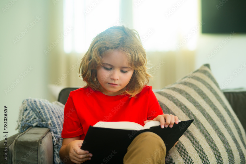 Concept of education, childhood, book reading, , artwork, inspiration. Child reading book at home. Little boy sitting on couch in living room reading story book. Kid doing homework for school. Concept of education, childhood, book reading, , artwork, inspiration. Child reading book at home. Little boy sitting on couch in living room reading story book. Kid doing homework for school.