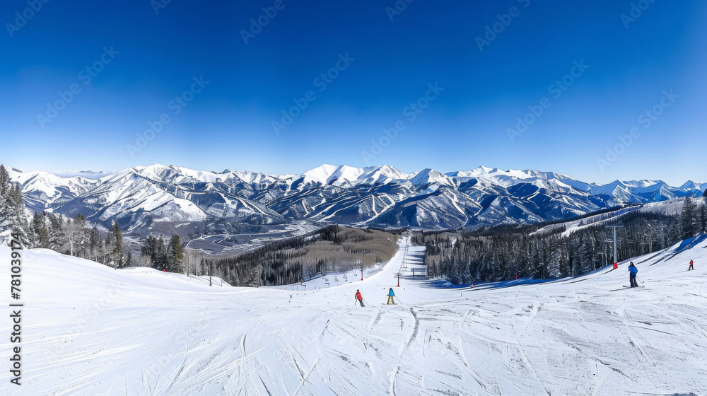 A snow covered mountain range with skiers on the slopes