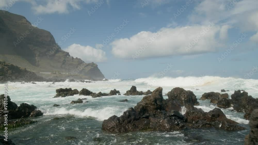 Slowmotion ocean waves crushing on sharp volcanic rocky beach near Punta Negra, Buenavista del Norte, Tenerife, Canary Islands in spring Slowmotion ocean waves crushing on sharp volcanic rocky beach near Punta Negra, Buenavista del Norte, Tenerife, Canary Islands in spring