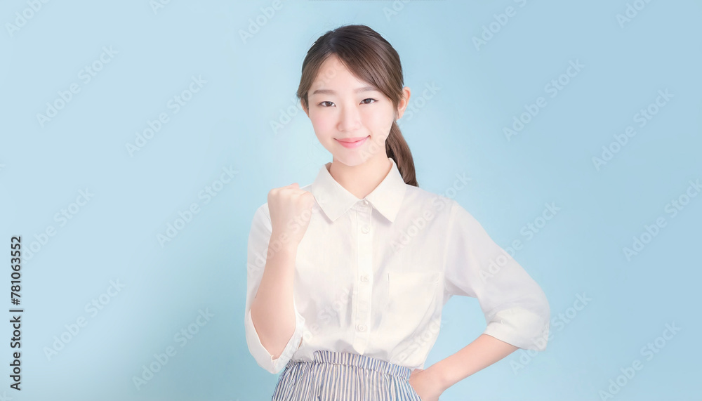 Young oriental woman with long hair wearing an apron doing a fist pump Young oriental woman with long hair wearing an apron doing a fist pump