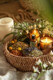 wicker basket overflowing with essential oils, dried herbs, and a candle, showcasing variety and abundance
