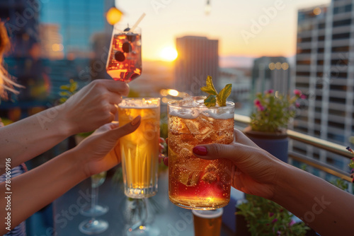 Hands toasting with refreshing drinks against a sunset cityscape backdrop