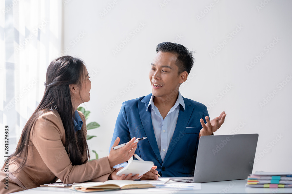 Business colleagues discuss and evaluate financial data together, reviewing charts on a document. Business colleagues discuss and evaluate financial data together, reviewing charts on a document.