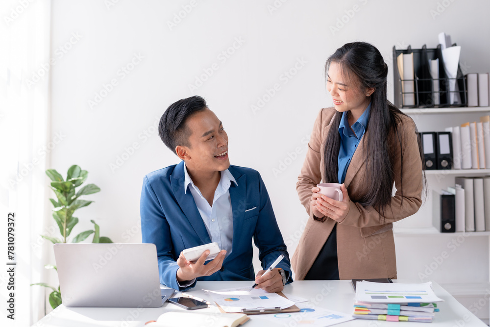 Business colleagues discuss and evaluate financial data together, reviewing charts on a document. Business colleagues discuss and evaluate financial data together, reviewing charts on a document.