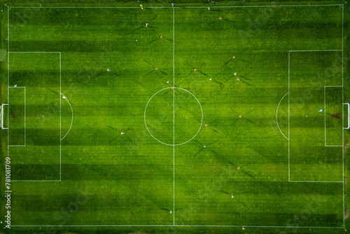 Aerial view of a soccer field in action, with players running, passing, and scoring goals. photo