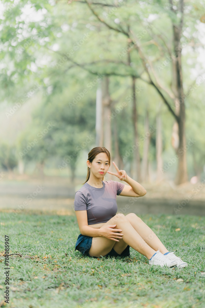Asian woman stretching and warming up before going for a run at the park. Yoga, health care, weight loss exercise. Asian woman stretching and warming up before going for a run at the park. Yoga, health care, weight loss exercise.