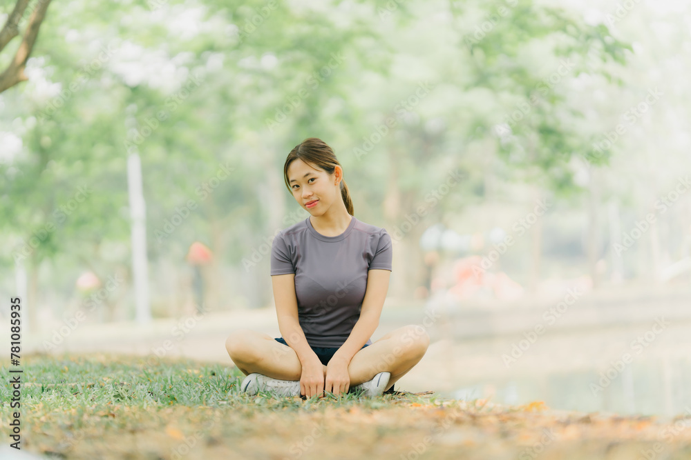 Asian woman stretching and warming up before going for a run at the park. Yoga, health care, weight loss exercise. Asian woman stretching and warming up before going for a run at the park. Yoga, health care, weight loss exercise.