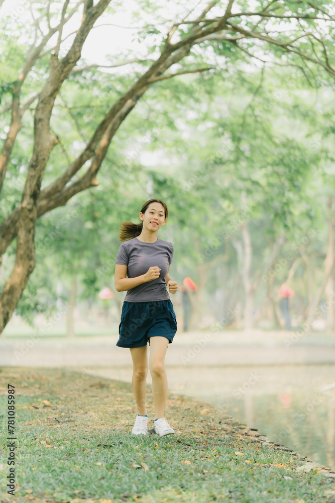 Asian woman stretching and warming up before going for a run at the park. Yoga, health care, weight loss exercise. Asian woman stretching and warming up before going for a run at the park. Yoga, health care, weight loss exercise.