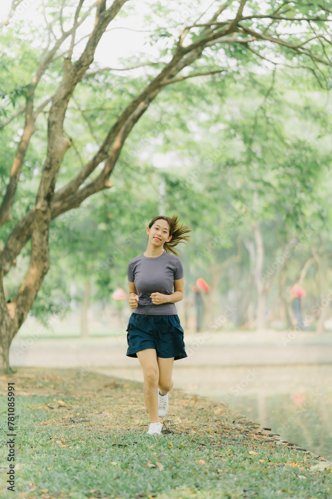 Asian woman stretching and warming up before going for a run at the park. Yoga, health care, weight loss exercise. Asian woman stretching and warming up before going for a run at the park. Yoga, health care, weight loss exercise.