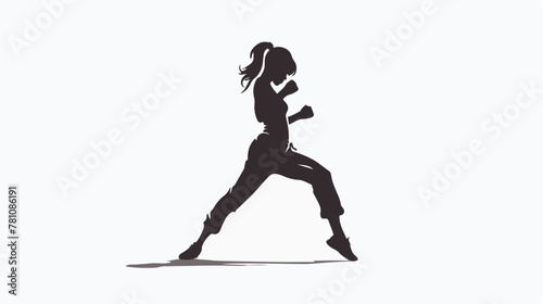 Silhouette of a woman doing a martial art kick. 